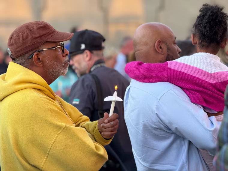 People gather outside the Teamsters Local 89 on Thursday for a vigil for the victims of a UPS plane crash this week in Louisville, Kentucky.
