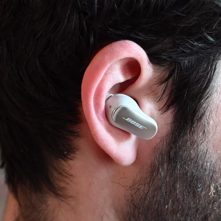 A close up of a Bose Quiet Comfort Ultra earbud in the ear of the writer.