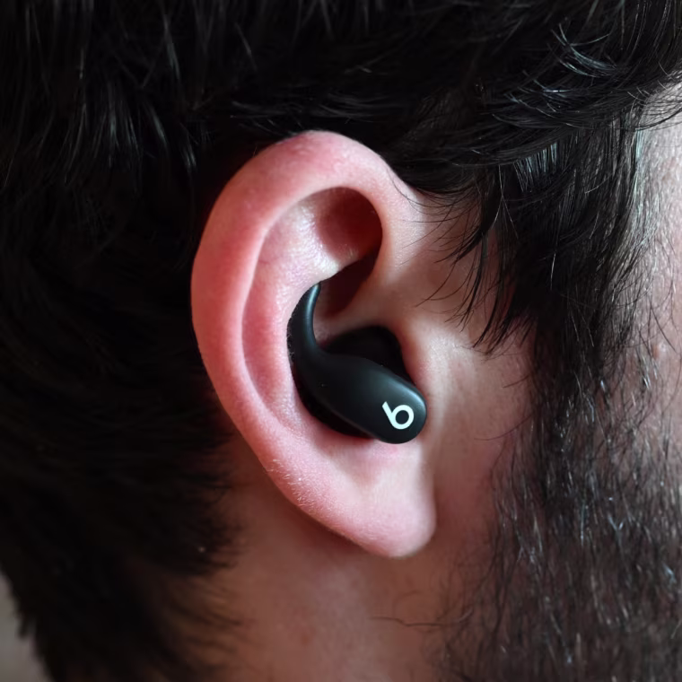A close up of a Beats Powerbeats Fit earbud in the ear of the writer.