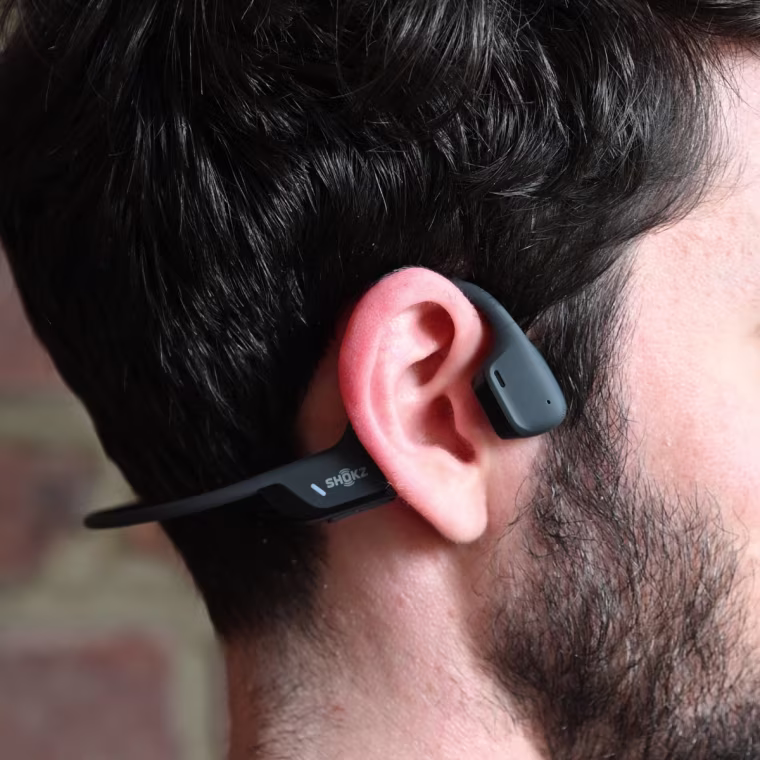 A close up of a Shokz Openrun Pro 2 on the ear of the writer.