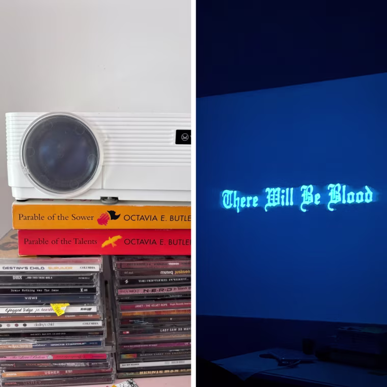 The Vankyo Projector sitting atop two stacks of CDs, on top of a pink metal dresser.