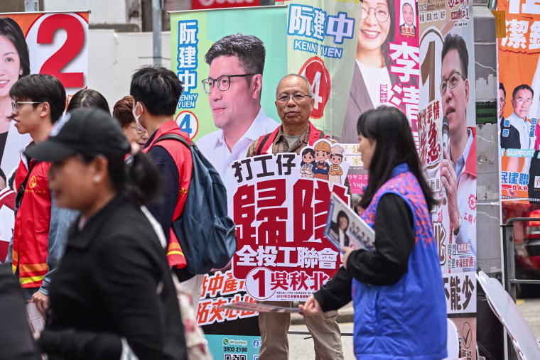 Supporters campaign for their candidates Sunday in the Legislative Council elections in Wanchai district of Hong Kong.