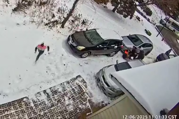 A woman runs from ICE agents in a driveway, one person is detained in the background