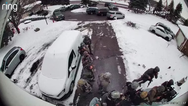 ICE agents stand outside of a home