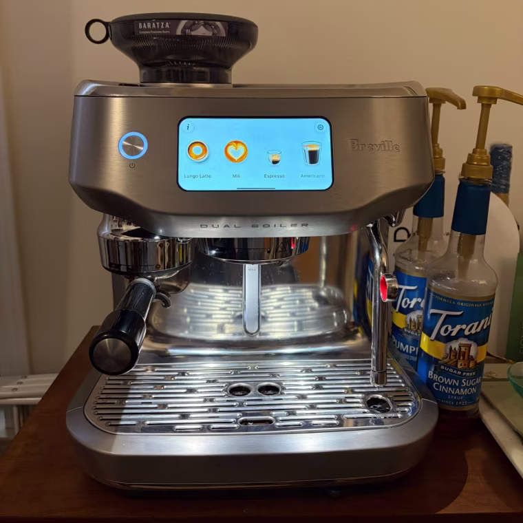 Espresso machine on dark wood counter