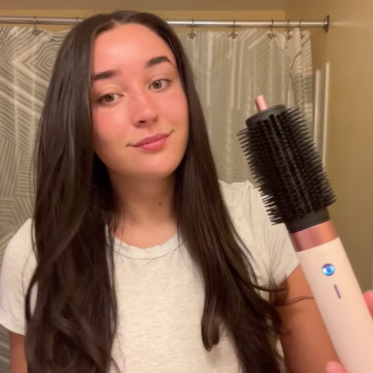 Woman using Dyson Airwrap to style her hair