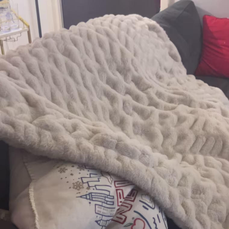 Blanket laying on back of couch
