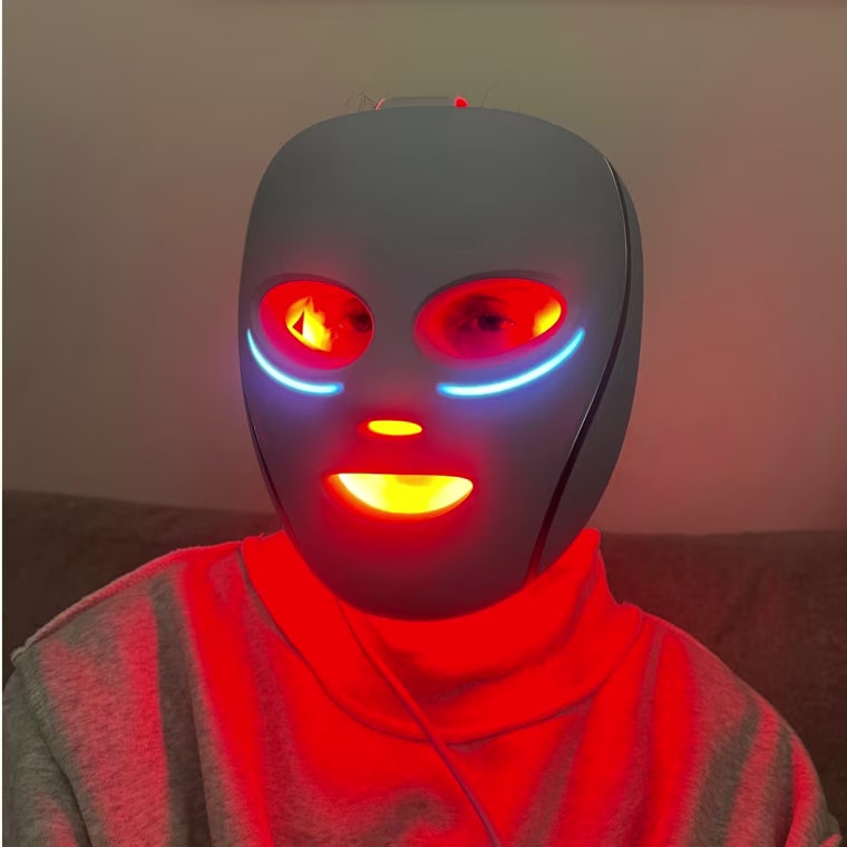 Woman wearing an LED red light therapy mask