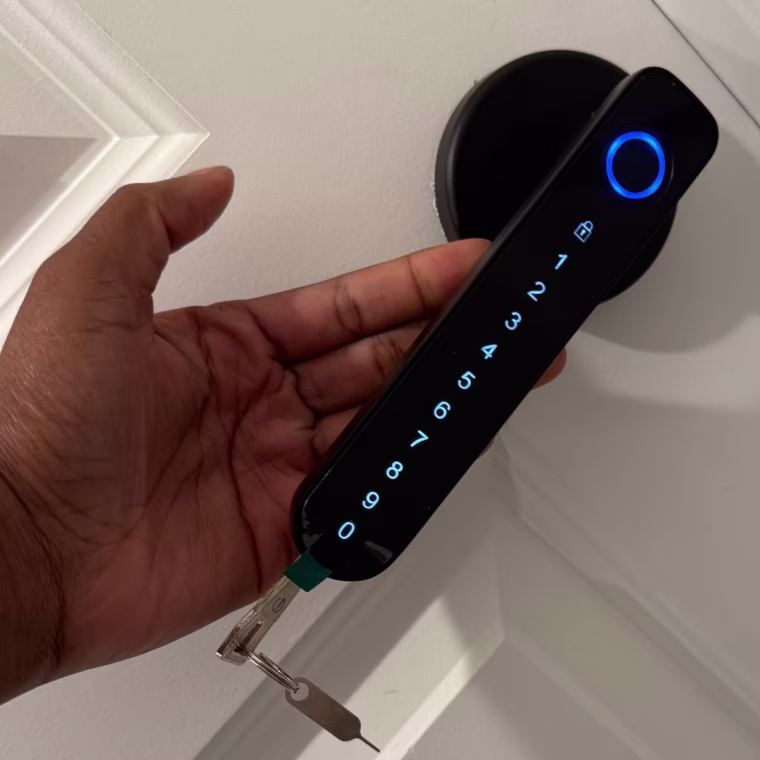 A hand behind a door handle with an LED touch button followed by numbers and a key at the end.