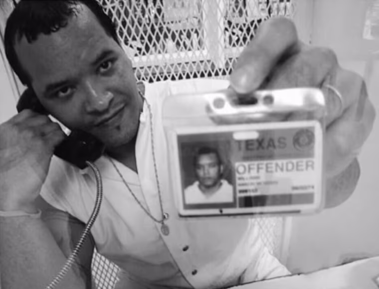 Nanon Williams holds up his prison ID.