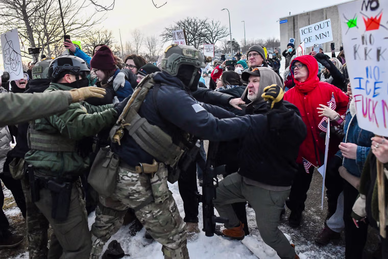 Image: Protestors clash with federal agents outside the Bishop Henry Whipple Federal Building
