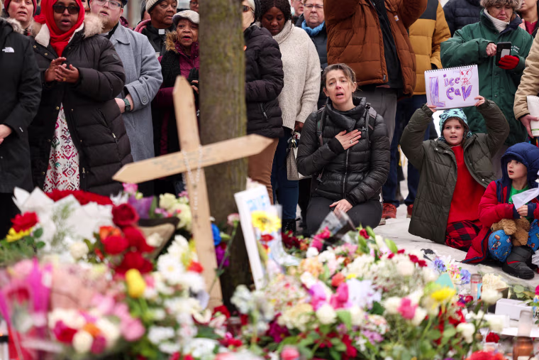 People gather at the street where 37-year-old Renee Nicole Good was shot and killed at point blank range on Jan. 7 by an ICE in Minneapolis, Minnesota, on January 8, 2026. 