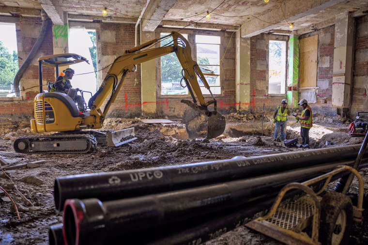 An excavator works on the ground floor of the 1951 Constitution Avenue Building on July 24, 2025.
