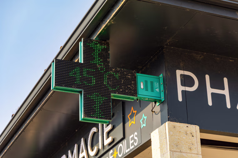 a thermometer above a pharmacy entrance shows 45 degrees Celsius