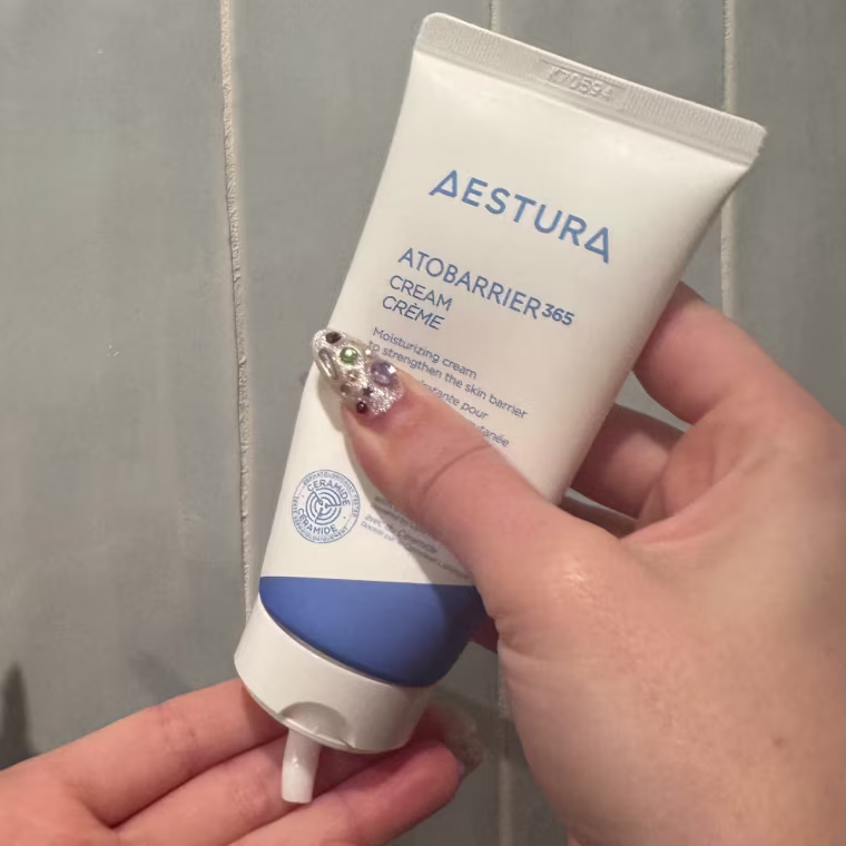 Woman dispensing cream on hand.