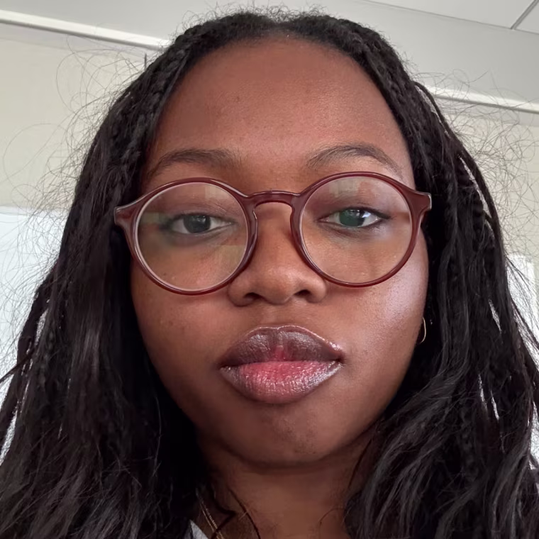 Woman applies silver tube of tinted lip balm