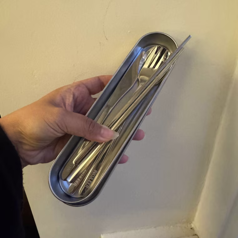 Photo of a hand holding the Inkuleer Travel Cutlery Set.
