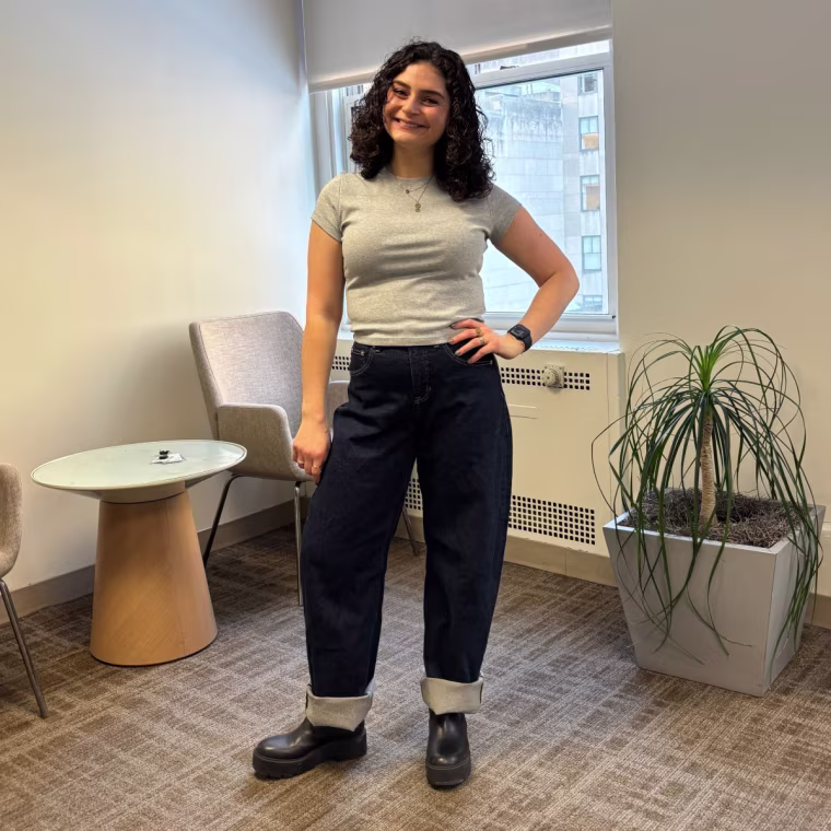 A woman wearing Spanx’s SpanxShape Authentic 360 Cuffed Horseshoe Jeans and a grey T-shirt.