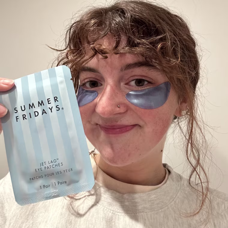 Woman wearing Summer Fridays eye patches and showing packaging