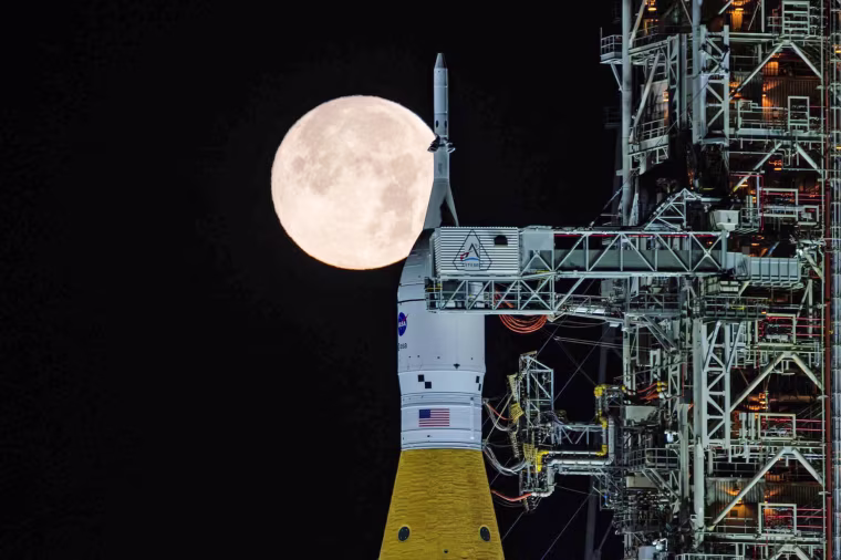 A full moon shines over NASA’s Space Launch System and Orion spacecraft on Sunday, Feb. 1, 2026, at NASA’s Kennedy Space Center in Florida.
