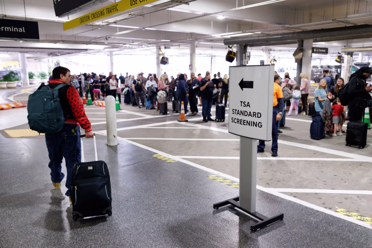 Travelers wait in line at a TSA checkpoint at William P. Hobby Airport in Houston, Texas, US, on Monday, March 9, 2026.