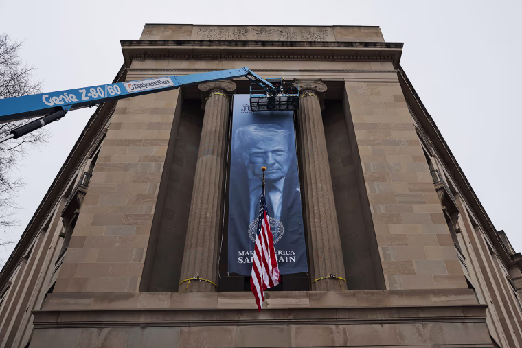A banner of President Donald Trump is hung on the Department of Justice on Feb. 19, 2026.