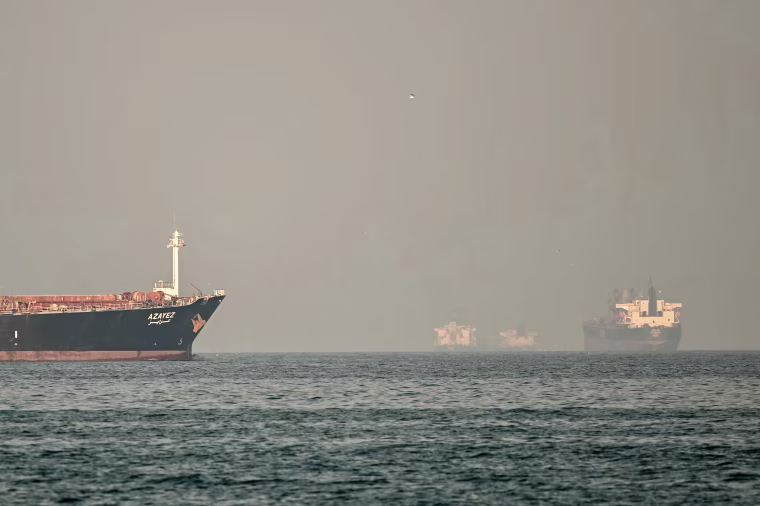 Four ships are partially obscured by fog.