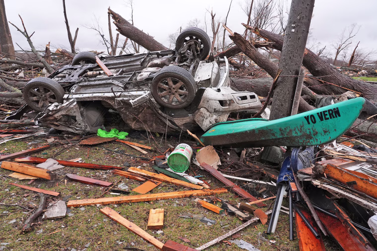 A damaged vehicle lies upside down on March 11, 2026, in the aftermath of a powerful storm that ripped through the day before in Aroma Park, Ill.