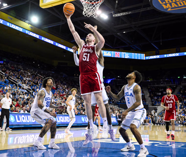 Rienk Mast scores past UCLA Bruins guards Eric Dailey Jr., Skyy Clark and Donovan Dent