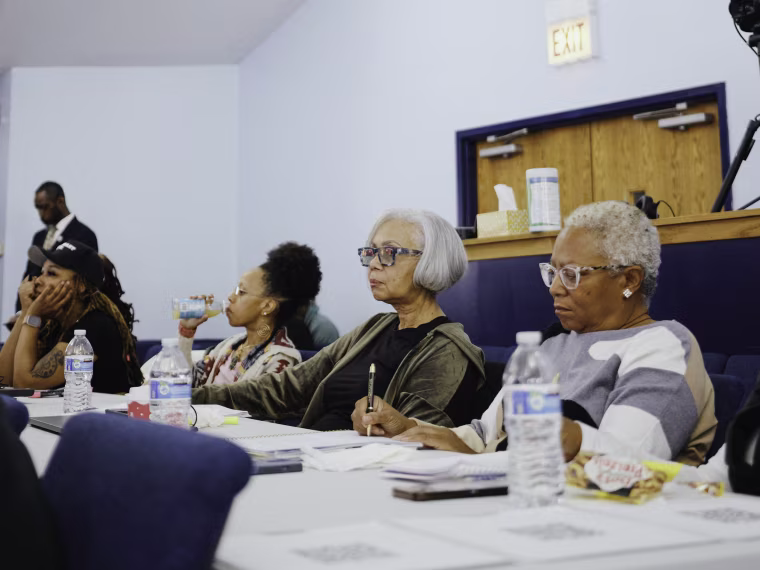 Attendees listens to Michelle Renee's crypto presentation at church.