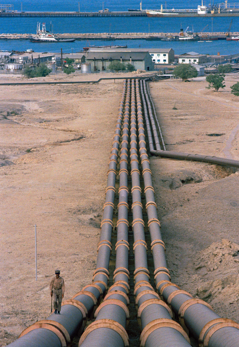 Pipes leading downhill toward the Kharg Island jetty in Iran from the 17 million-barrel-capacity tank farm in 1971.