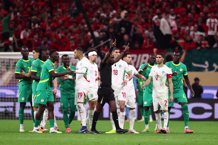 A referee calls for video review during the final between Senegal and Morocco on Jan. 18, 2026. 