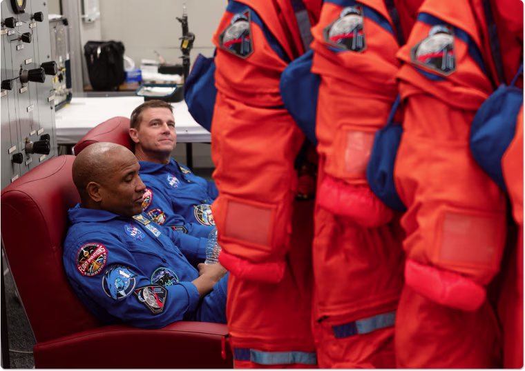 Victor Glover and Reid Wiseman alongside the Orion Crew Survival System spacesuits on Jan. 17.
