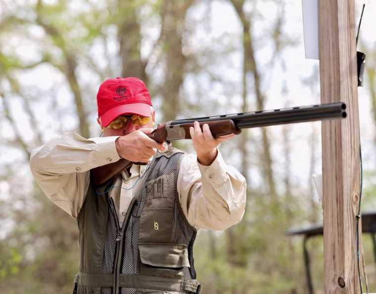 Lindsey Graham holds a gun outside
