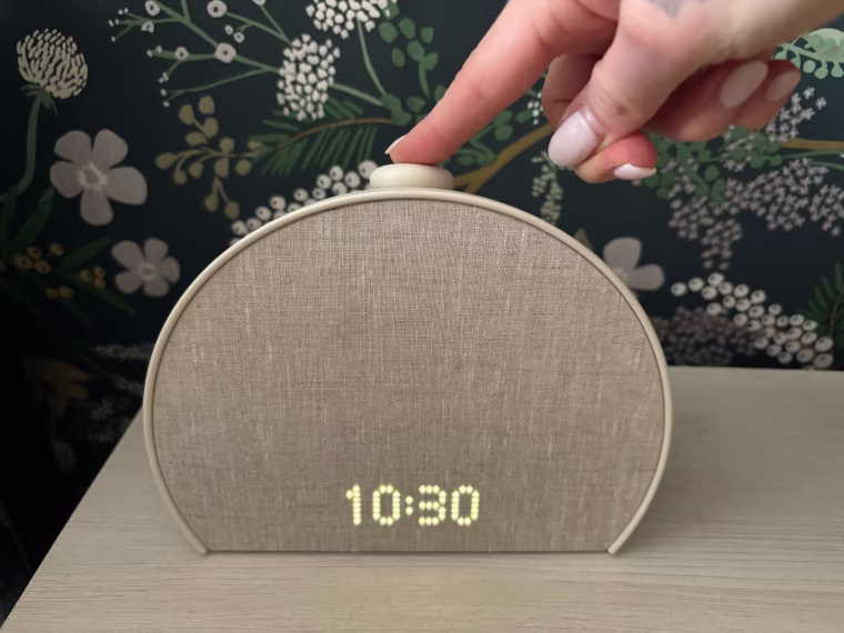 Woman turning off her Hatch alarm clock
