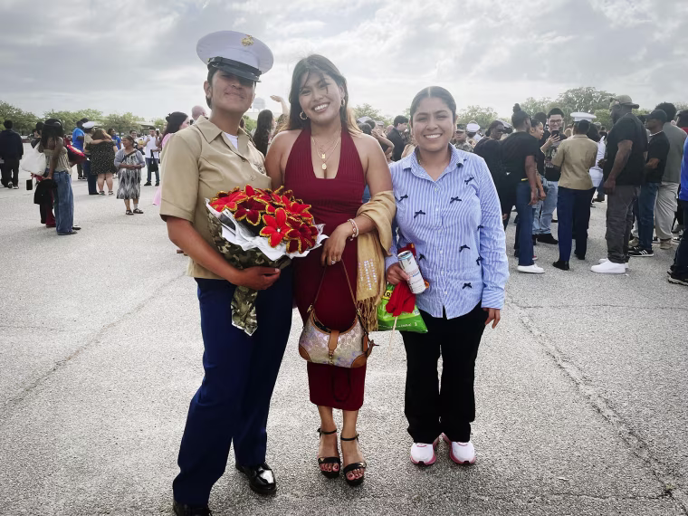 U.S. Marines graduate Pvt. Ramirez Garcia, her wife and her sister, right, Emily Ramirez pose after the graduation.