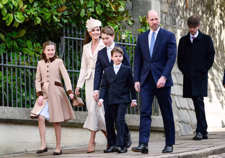 From left, Princess Charlotte of Wales, Catherine, Princess of Wales, Prince George of Wales, Prince Louis of Wales and Prince William, Prince of Wales walk outside on a sidewalk