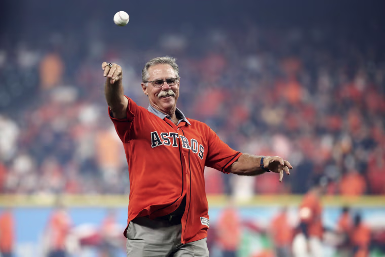 Phil Garner wears an untucked Astros jersey while casually throwing a baseball.