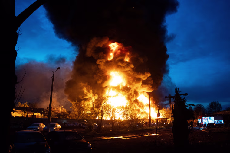 TOPSHOT: Fire burns at the site of recycling materials following a Russian strike in Kyiv