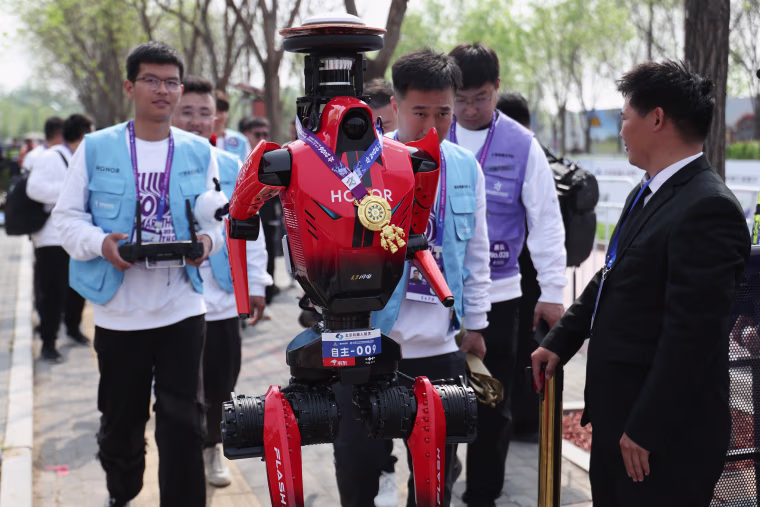 The winning robot, from Chinese smartphone manufacturer Honor, accepts media interviews after the Beijing E-Town Humanoid Robot Half-Marathon on Sunday.