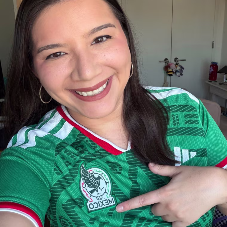Woman wearing Mexico Adidas jersey.