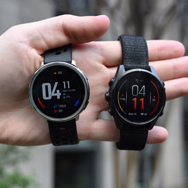 The Amazfit Active 2 and Garmin Fenix 8 in the hand of the writer.