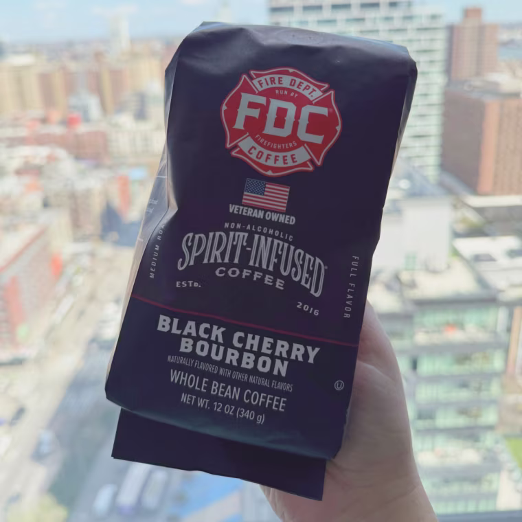 Fire Dept. Coffee Beans in front of a window with a city view.
