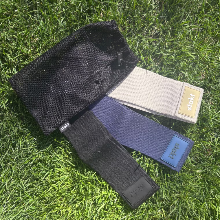 Three resistance bands laying on grass