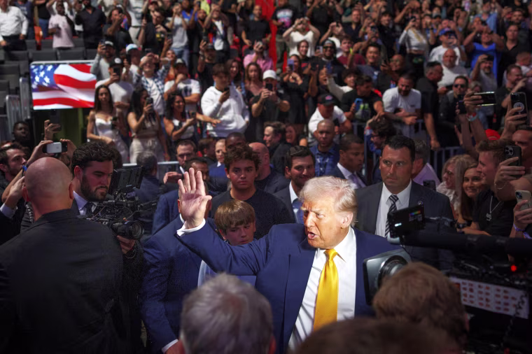 President Donald Trump waves to a cheering crowd.
