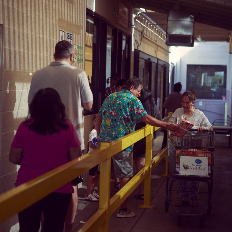 People wait in line at St. Mary’s Food Bank