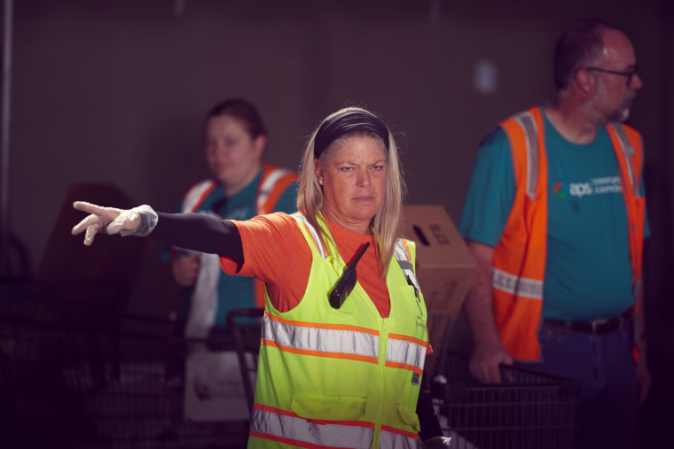 A volunteers at St. Mary’s Food Bank in Phoenix directs traffic the morning of April 29.