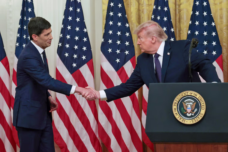 President Donald Trump shakes hands with Kevin Warsh=