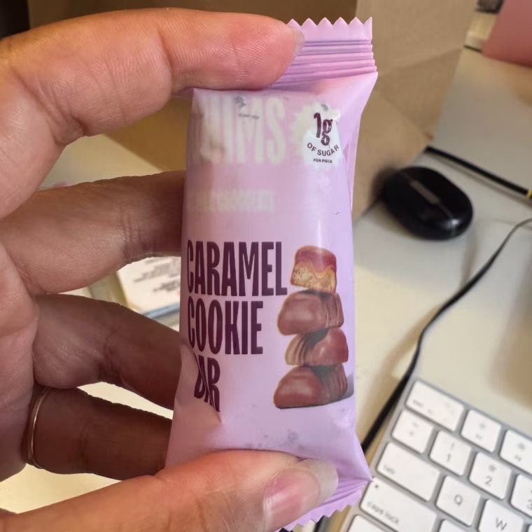 Person holding Whims Oat Milk Chocolate Caramel Cookie Bar.
