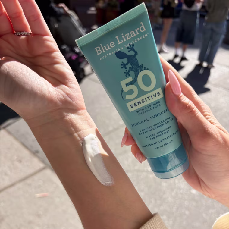 Woman applying sunscreen to arm